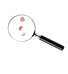 a magnifying glass showing specks of lead dust that can be detected during dust wipe sampling